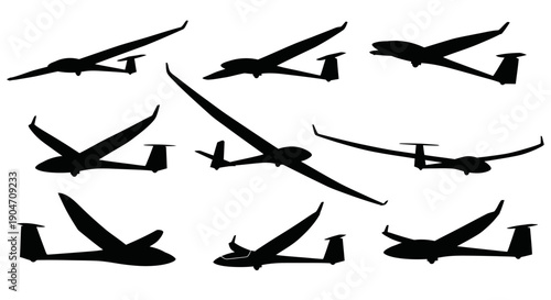 Silhouettes of various gliders in flight on white background