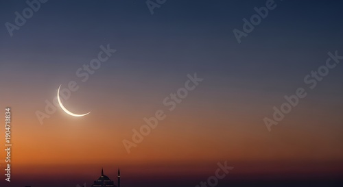 Thin crescent moon hovers over dark horizon at twilight.