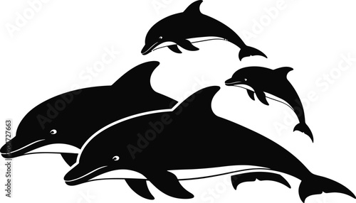 Silhouette of three dolphins swimming together in ocean water