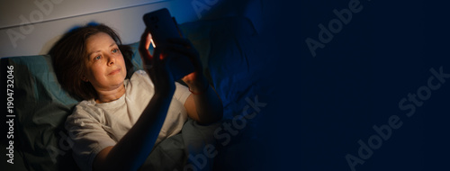 Slika na platnu Lonely woman in bed at night using smartphone and suffering from insomnia, femal