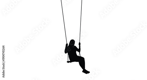 A solitary figure swings peacefully captured in dark silhouette