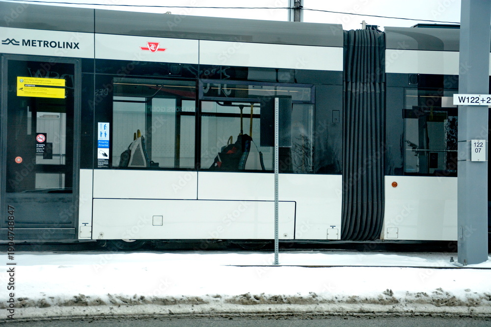 Fototapeta premium Toronto, Ontario, Canada, February 6, 2026: A Metrolinx Eglinton Crosstown LRT test train makes its way along the transit line in Scarborough. This LRT line, after waiting for years to open, is now sc