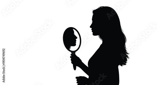 Woman looking into a handheld mirror a dramatic silhouette