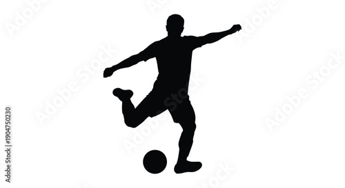 A dynamic soccer player kicking a ball in dark silhouette