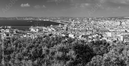 Panoramic aerial view od Marseille old port and its Mediterranean coastline; famous travel landmark city skyline of Marseille, Provence, France in black and white