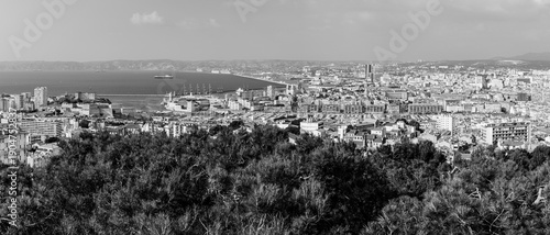 Panoramic aerial view od Marseille old port and its Mediterranean coastline; famous travel landmark city skyline of Marseille, Provence, France in black and white