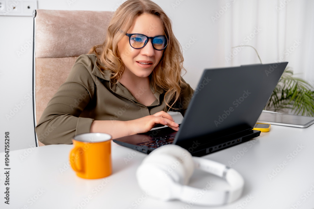 Fototapeta premium Confused woman looking at laptop screen with blue light reflection on glasses due to system error or software glitch