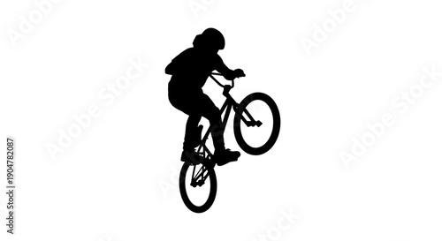 Professional cyclist performing daring stunt on bike in mid air