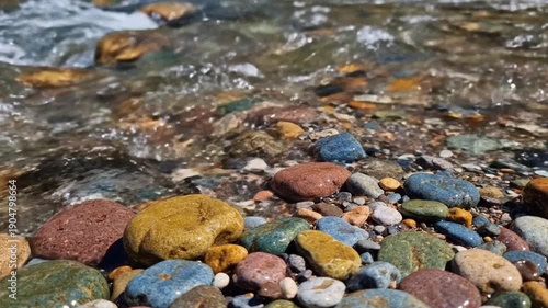 Clear Stream Flowing Over Colorful River Stones
