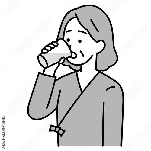 バリウムを飲む検査着の年配の女性