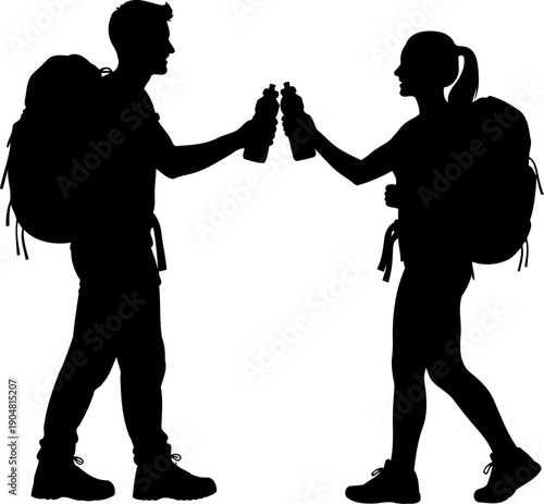 Hiking couple silhouette toasting with water bottles outdoors