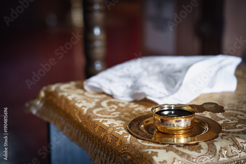 A wedding in an Orthodox Church.  White towels and a bowl of wine on the table