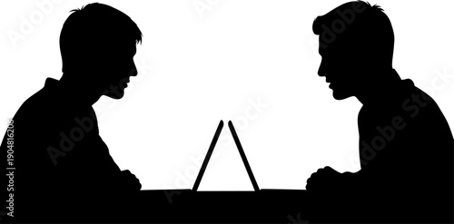Two businessmen working on laptops facing each other at a desk
