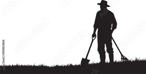 Man in hat holding shovel and rake in silhouette