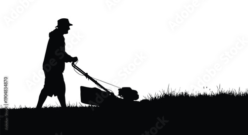 Man mowing lawn with a push lawn mower on a grassy field