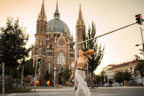 Wallpaper Mural Young woman walking across street in Vienna at sunset Torontodigital.ca