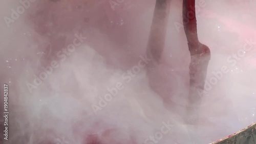 Cotton is dyed with lac dye to obtain natural colors using a traditional method in a hot pot.