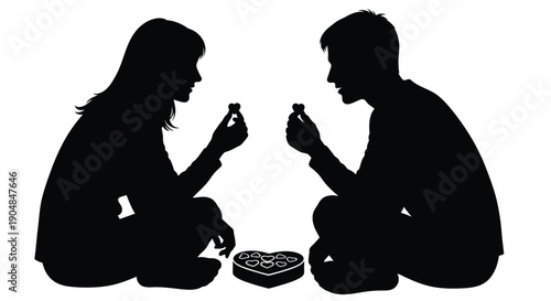 A couple sharing a meal with a heart shaped box a striking silhouette