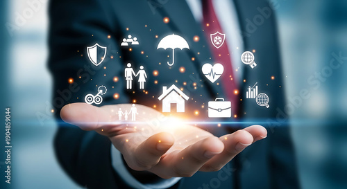 Businessman's hand displaying a holographic interface with various icons symbolizing insurance services and life protection
