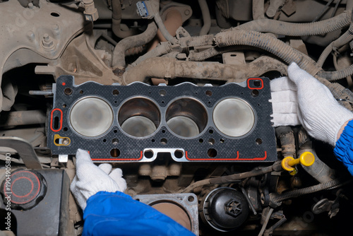 Принти на полотні Close-up of a mechanic’s gloved hands installing a new cylinder head gasket on an open engine block during vehicle repair