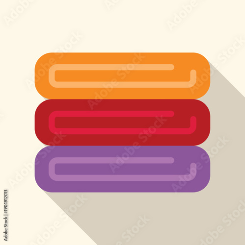Stack of clean folded towels in orange, red, and purple with a long shadow