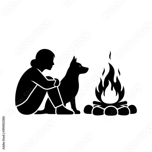 Silhouette of a person and dog sitting by a campfire