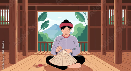 Woman crafting a traditional Vietnamese conical hat indoors.
