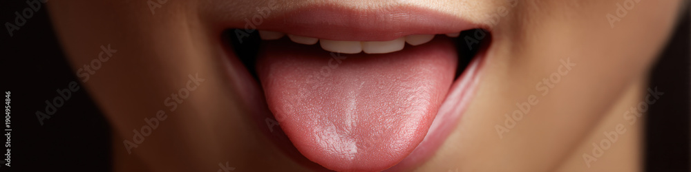 Fototapeta premium Close-up of female mouth with tongue sticking out