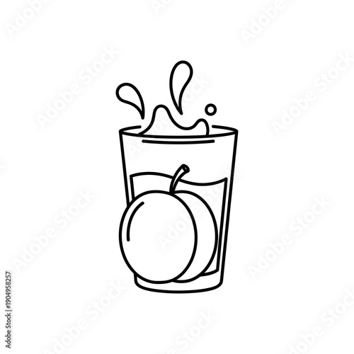 A glass of juice with an apple splashing into it from above outdoors