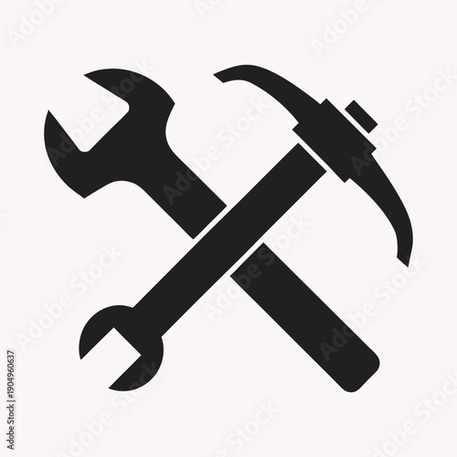 Black silhouette of a wrench and a pickaxe crossed on a white background Keywords: wrench, pickaxe, tool, construction, repair, industry