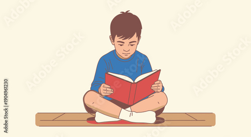 Boy engrossed in reading a book while sitting crosslegged 2.
