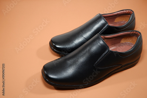 Fényképezés Classic black leather slip-on loafer dress shoes showcasing professional footwea