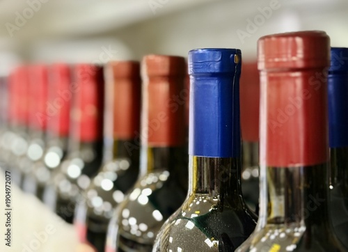 Elegant Wine Display. Luxurious Bottles Arranged Attractively. Upscale Retail Setting Features Carefully Displayed Premium Wines Under Warm Lighting For Tasting And Purchase