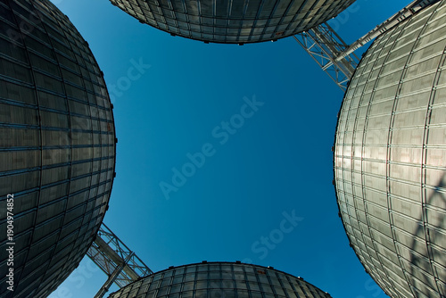 Industrial series of silver grain silos and port terminal logistics.