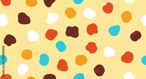Colorful irregular shapes scattered across a vibrant yellow surface viewed from directly above