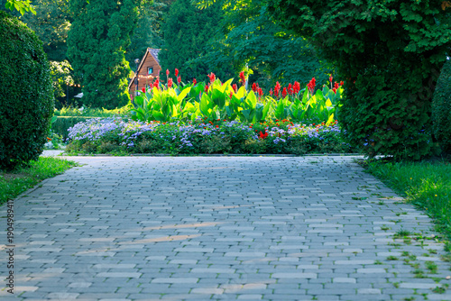 spring season park paved road to square flower bed blossom plants landscaped natural colorful view sunny day