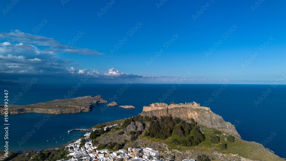 Fototapeta premium Rhodes, Greece. Lindos small whitewashed village and the Acropolis, scenery of Rhodos Island at Aegean Sea.