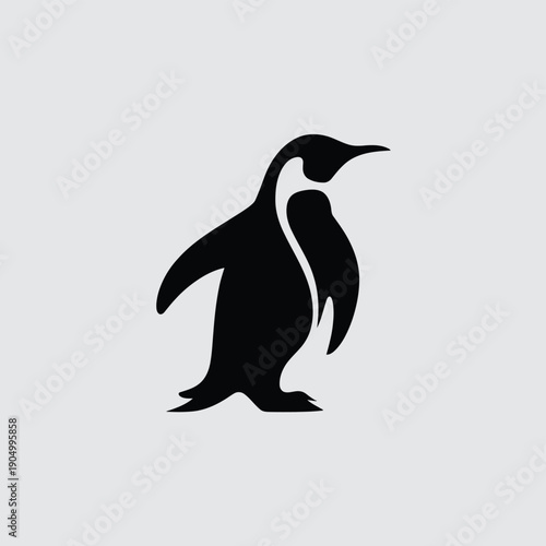 A sleek black and white silhouette of a standing penguin against a plain background. isolated on white background, Vector, illustration