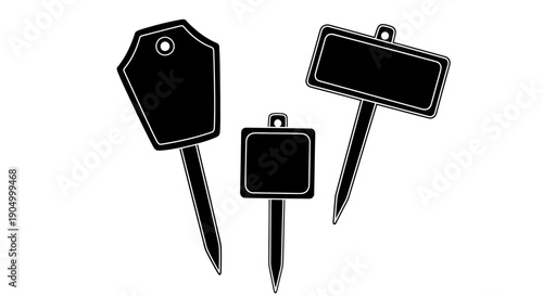Three blank black signs on sticks isolated on a clean white background viewed from directly above