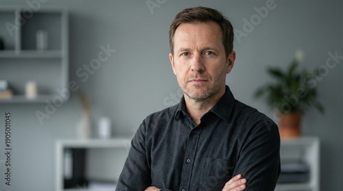 Confident Mid-Adult Businessman with Serious Expression Posing in Modern Office