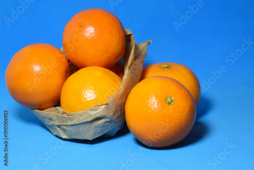 Bilde på lerret Natural oranges on a blue background.