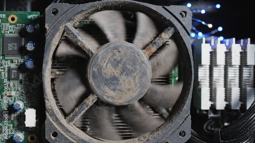 Dusty computer CPU fan on motherboard with RAM modules.