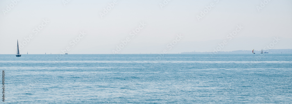 Obraz premium Sailboats dotting lake constance on summer day