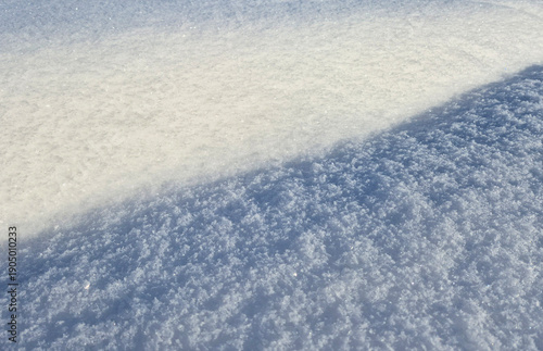 Snowy double background. Shadow and light. Snow glitters in the sun.