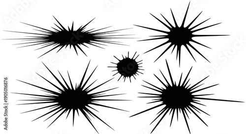 A group of black spiky illustrations arranged closely on a plain surface viewed from directly above