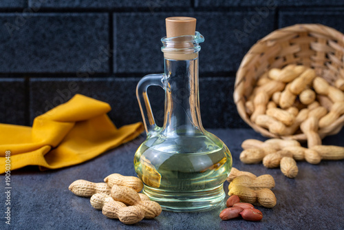 Peanut oil in glass bottle and peanuts