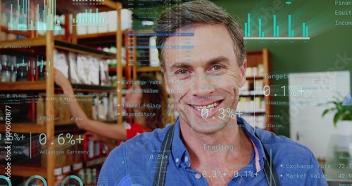 Smiling owner wearing blue shirt dark apron standing in store with wooden shelving, fintech HUD