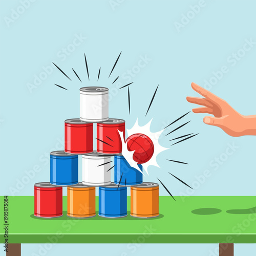 Tin can game with a ball hitting pyramid of cans on a table at a carnival