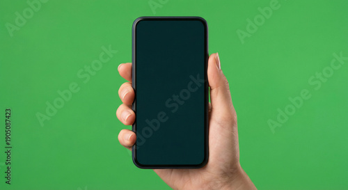 Wallpaper Mural Hand Holding Smartphone with Dark Screen on Green Background for Mockup Torontodigital.ca