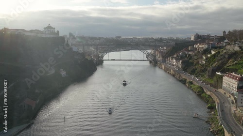 Porto bridge perspective of the iconic iron bridge with a small boat passing.